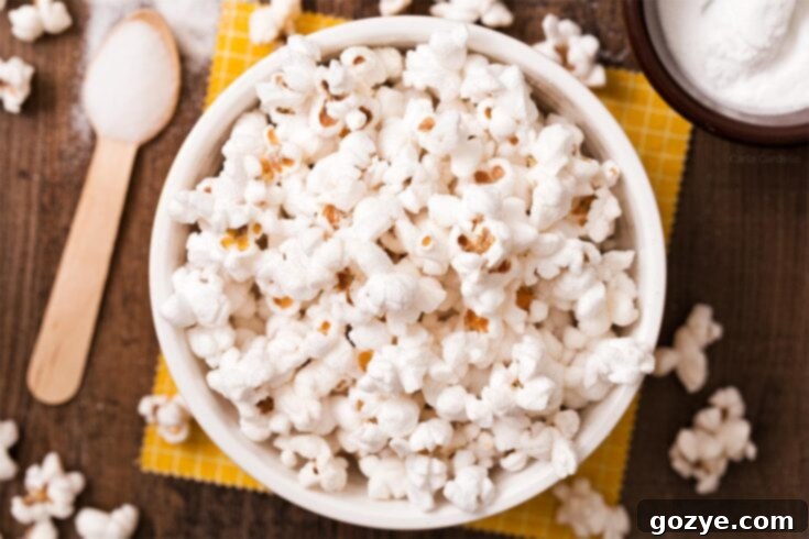 A Pinterest pin image for Salt and Vinegar Popcorn, featuring a bowl of the snack.