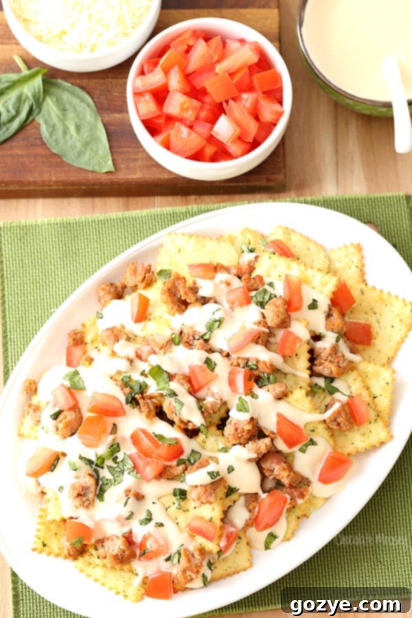 Italian Nachos with hot sausage, mozzarella cheese, tomatoes, basil, and Pasta Chips