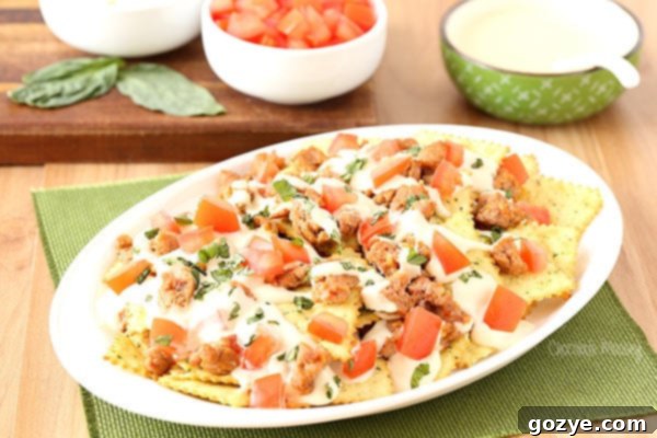 Italian Nachos with hot sausage, mozzarella cheese, tomatoes, basil, and Pasta Chips