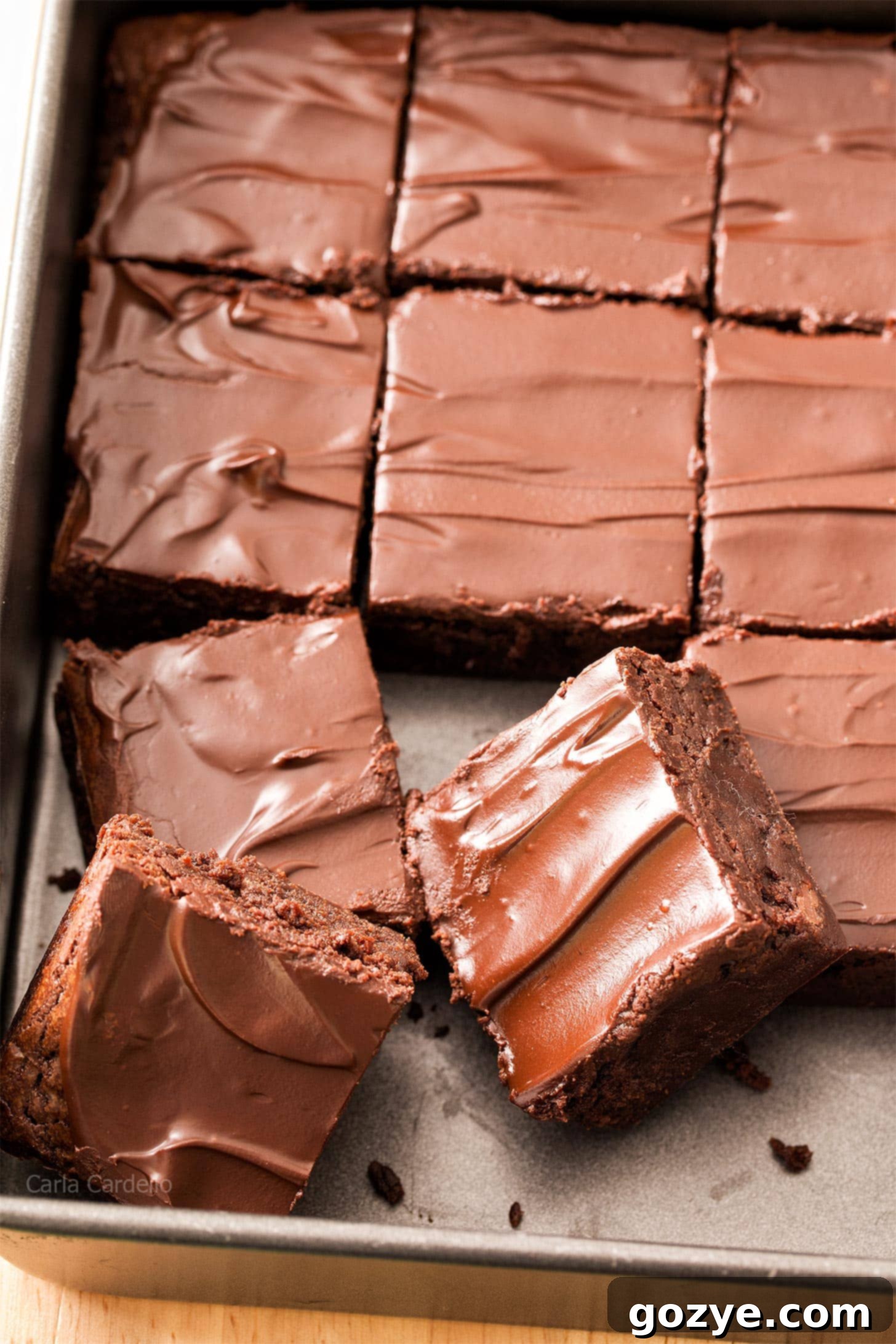 Decadent Guinness Brownies 2 Close up of a square pan filled with baked Guinness Brownies, showing their rich, dark color and fudgy texture. Some brownies are cut, revealing their moist interior.