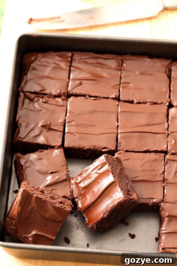 Decadent Guinness Brownies 4 A close-up of Guinness Brownies in an 8x8 pan, freshly baked with a shiny chocolate glaze on top. The edges are crisp, and the center looks perfectly fudgy.