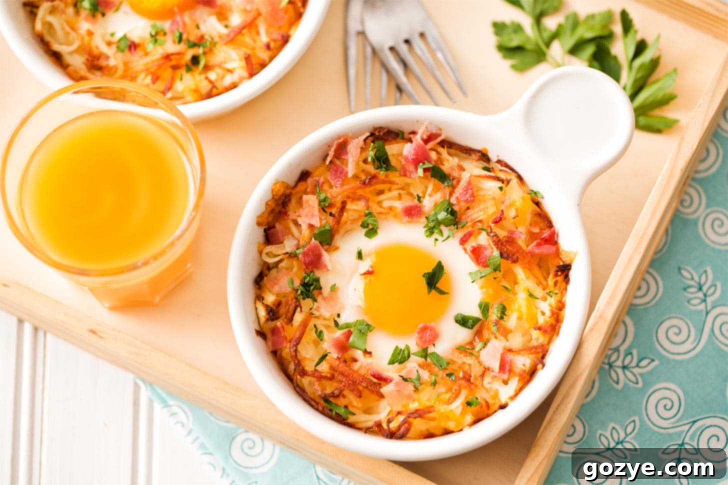 A single baked egg in hash browns, perfectly formed in a ramekin