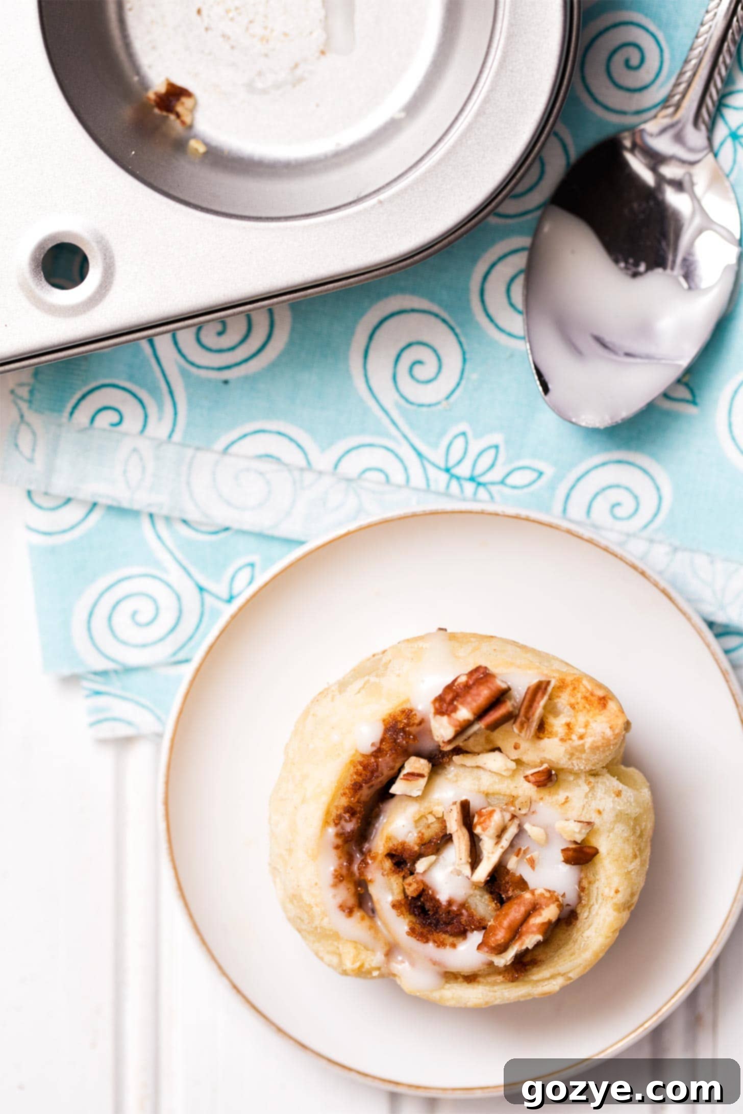 Single puff pastry cinnamon roll on a white plate