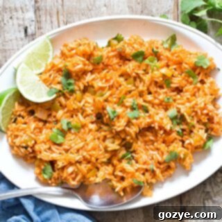 Spanish Rice on white platter with lime slices