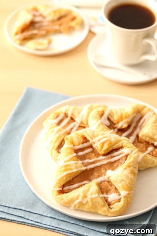 Flaky Danish Pastries 6 Puff Pastry Danish on white plate with coffee