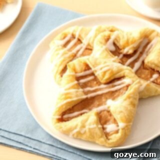 Flaky Danish Pastries 7 Puff Pastry Cream Cheese Danish on white plate with blue linen