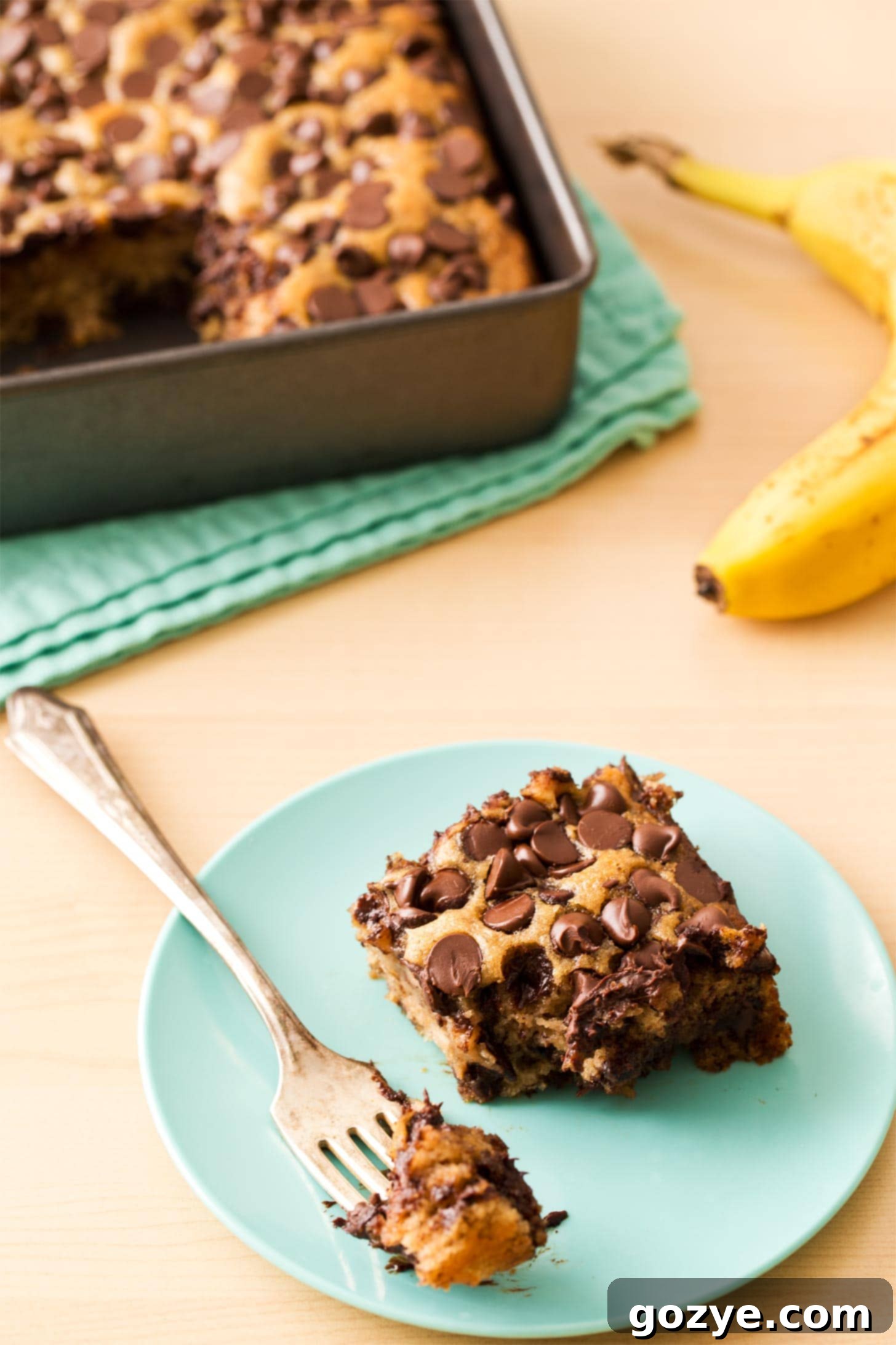Slice of banana snack cake on blue plate