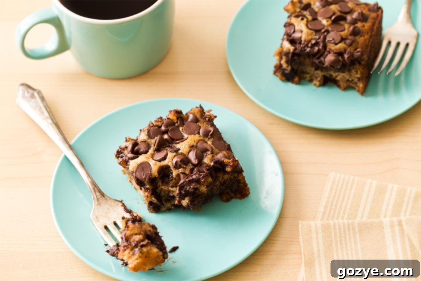 Two slices banana chocolate chip cake on blue plates
