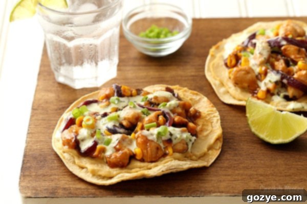 Barbecue chicken and corn on top of oven baked tostadas with hummus