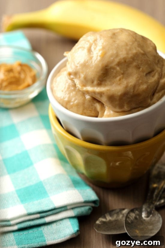 Creamy Peanut Butter Banana Ice Cream made without an ice cream machine, served in a bowl with a spoon