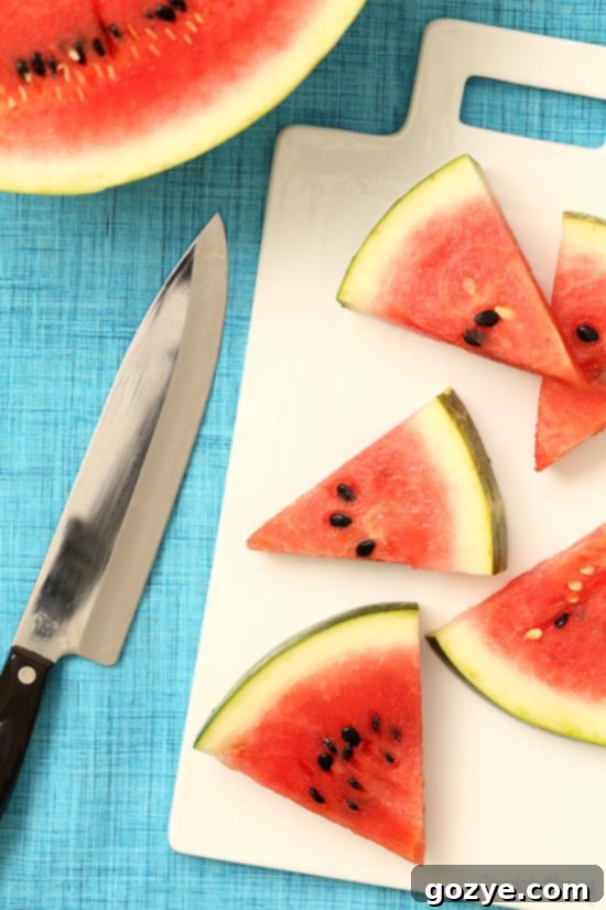 Freshly sliced watermelon arranged beautifully on a wooden cutting board, ready for pureeing