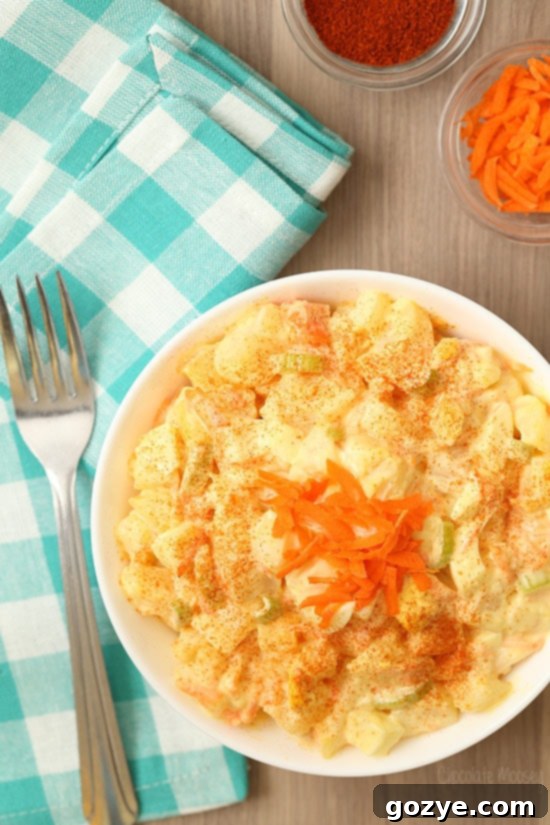 Amish potato salad in a white bowl with turquoise linen