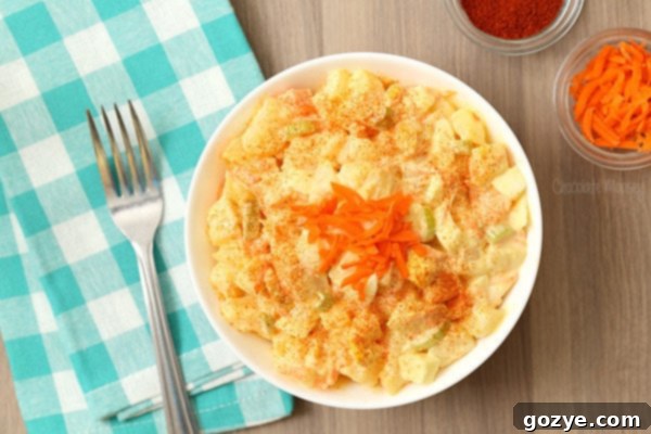 Amish potato salad in a white bowl with turquoise linen
