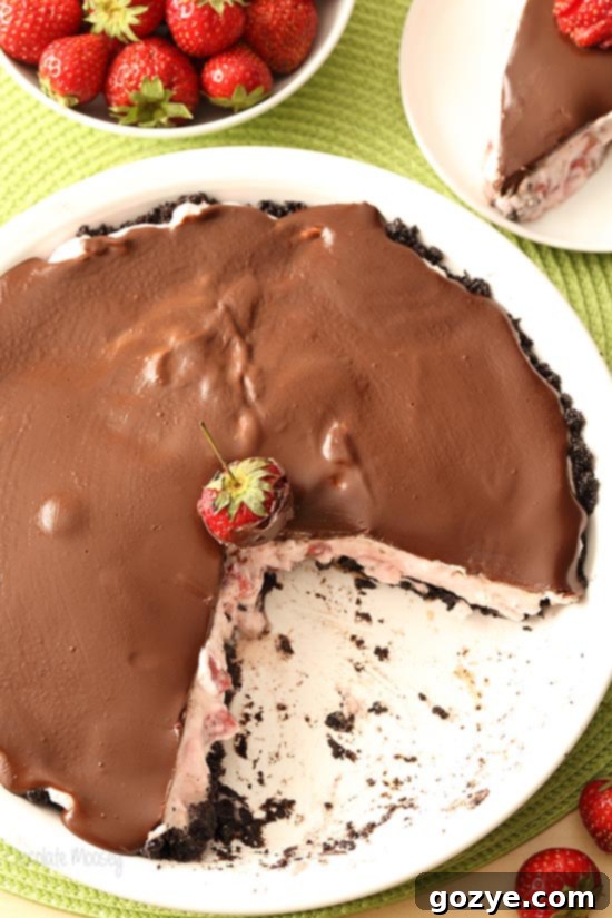 Close-up of a Strawberry Cream Cheese Pie with a smooth chocolate ganache topping, ready to be chilled.