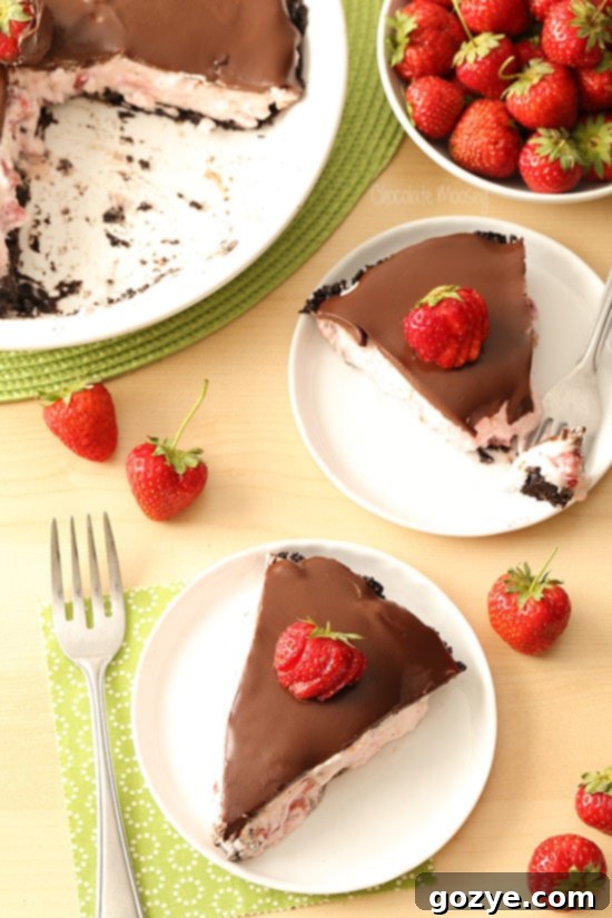 Multiple slices of Strawberry Cheesecake Pie on a serving platter, showcasing the beautiful layers.
