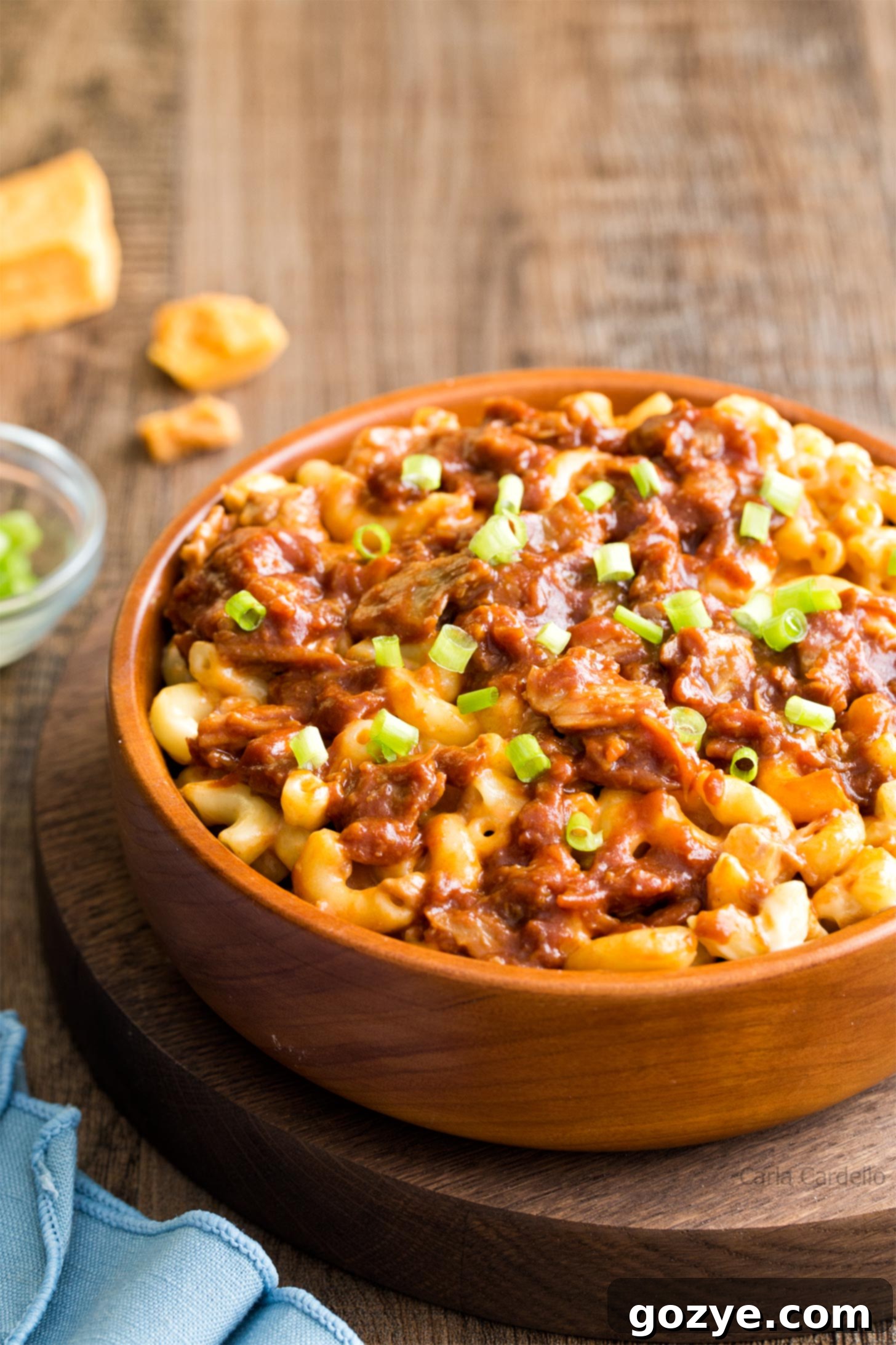 Ultimate Pulled Pork Mac and Cheese 2 Pulled pork mac and cheese in a rustic brown bowl, showcasing creamy texture and meat