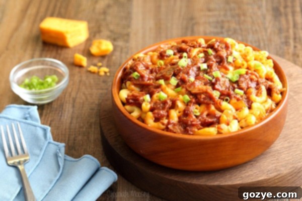 Ultimate Pulled Pork Mac and Cheese 4 A brown bowl filled with mac and cheese and generous portions of pulled pork