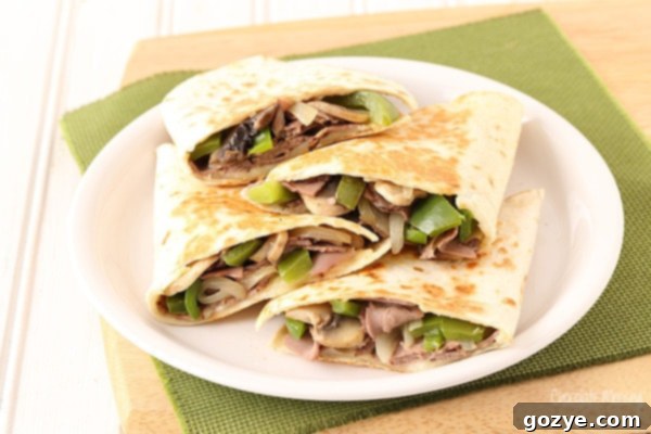 Close-up of golden-brown Philly Cheesesteak Quesadillas filled with savory meat, melted cheese, and tender vegetables