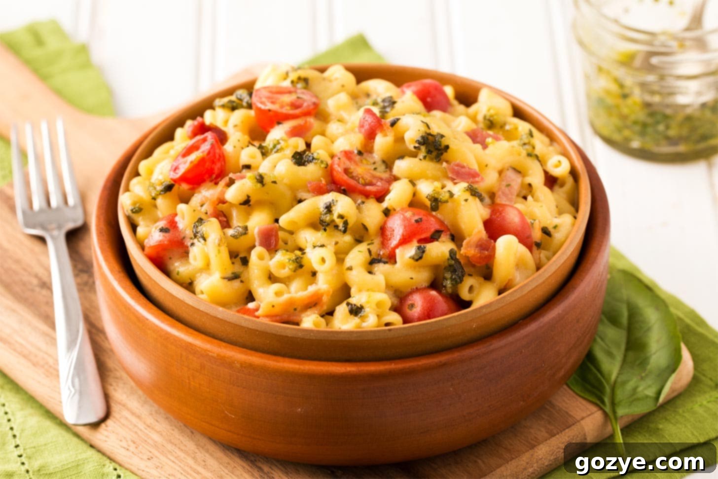 Close-up of macaroni coated with basil pesto sauce in a bowl
