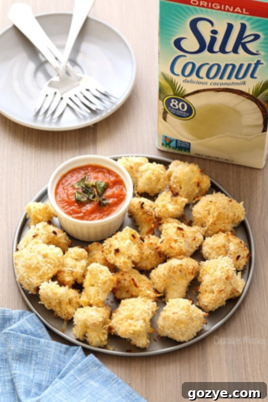 Coconut Crusted Baked Cauliflower Bites with homemade marinara sauce