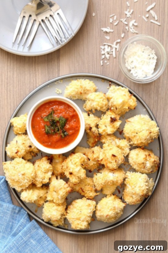 Coconut Crusted Baked Cauliflower Bites with homemade marinara sauce