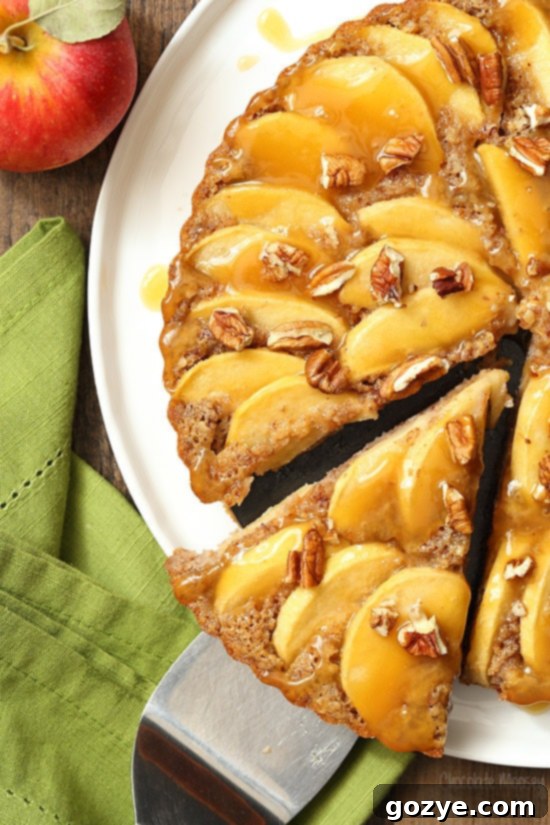 Rustic Caramel Apple Pecan Tart cooling on a wire rack, showcasing the golden-brown crust and imperfectly arranged apple slices, adding to its charm.