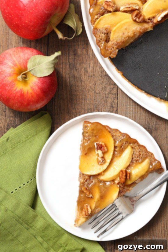 Caramel Apple Pecan Tart with a generous drizzle of extra caramel sauce and a sprinkle of chopped pecans on top, ready to be served.