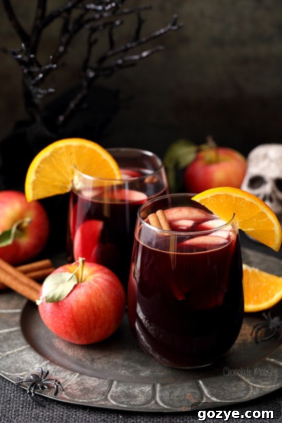 Ruby Apple Cider Sangria 2 Apple Cider Sangria on pewter plate with Halloween decorations