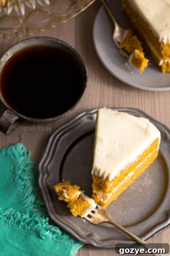 Slice of Pumpkin Layer Cake showing moist texture and frosting.