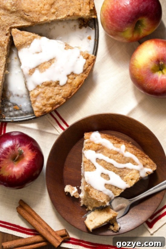 Slice of Apple Cinnamon Coffee Cake with cinnamon streusel and sweet vanilla icing