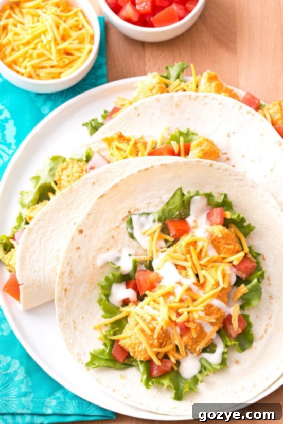 Zesty Buffalo Chicken Tacos 3 An unfolded buffalo chicken taco, revealing the crispy chicken, lettuce, and cheese