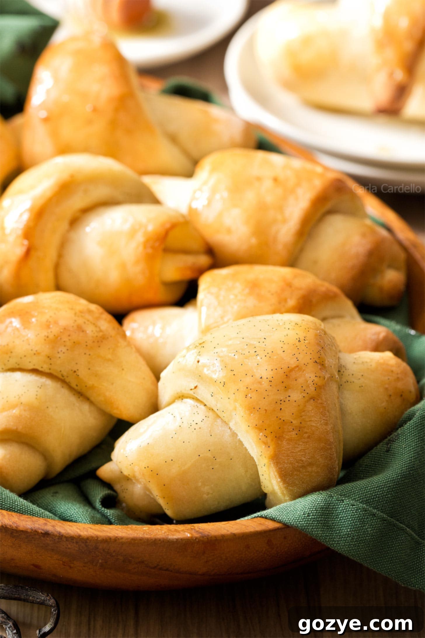 Close up of soft and fluffy homemade crescent rolls, golden brown with a slight sheen
