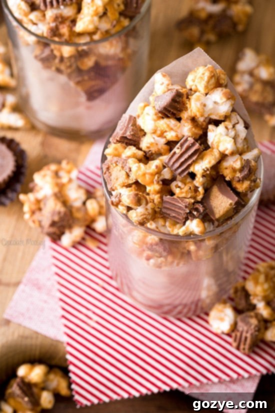Peanut Butter Cup Popcorn served in a waxed paper cone, showcasing its delightful appearance