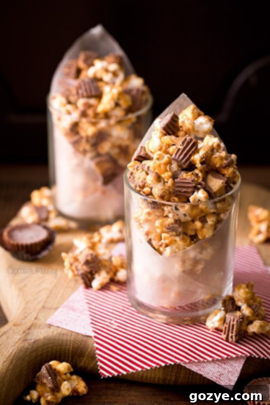 Close-up of Peanut Butter Cup Popcorn with a rich peanut butter coating and small peanut butter cups
