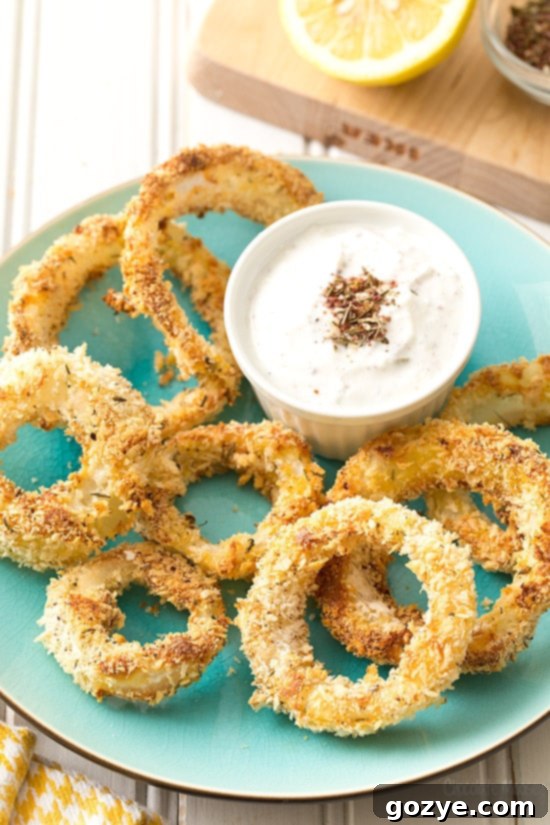 A close-up of Za'atar Baked Onion Rings, ready to be enjoyed with dipping sauce