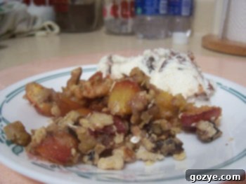 Warm Nectarine Crisp in a serving dish, topped with a crumble.