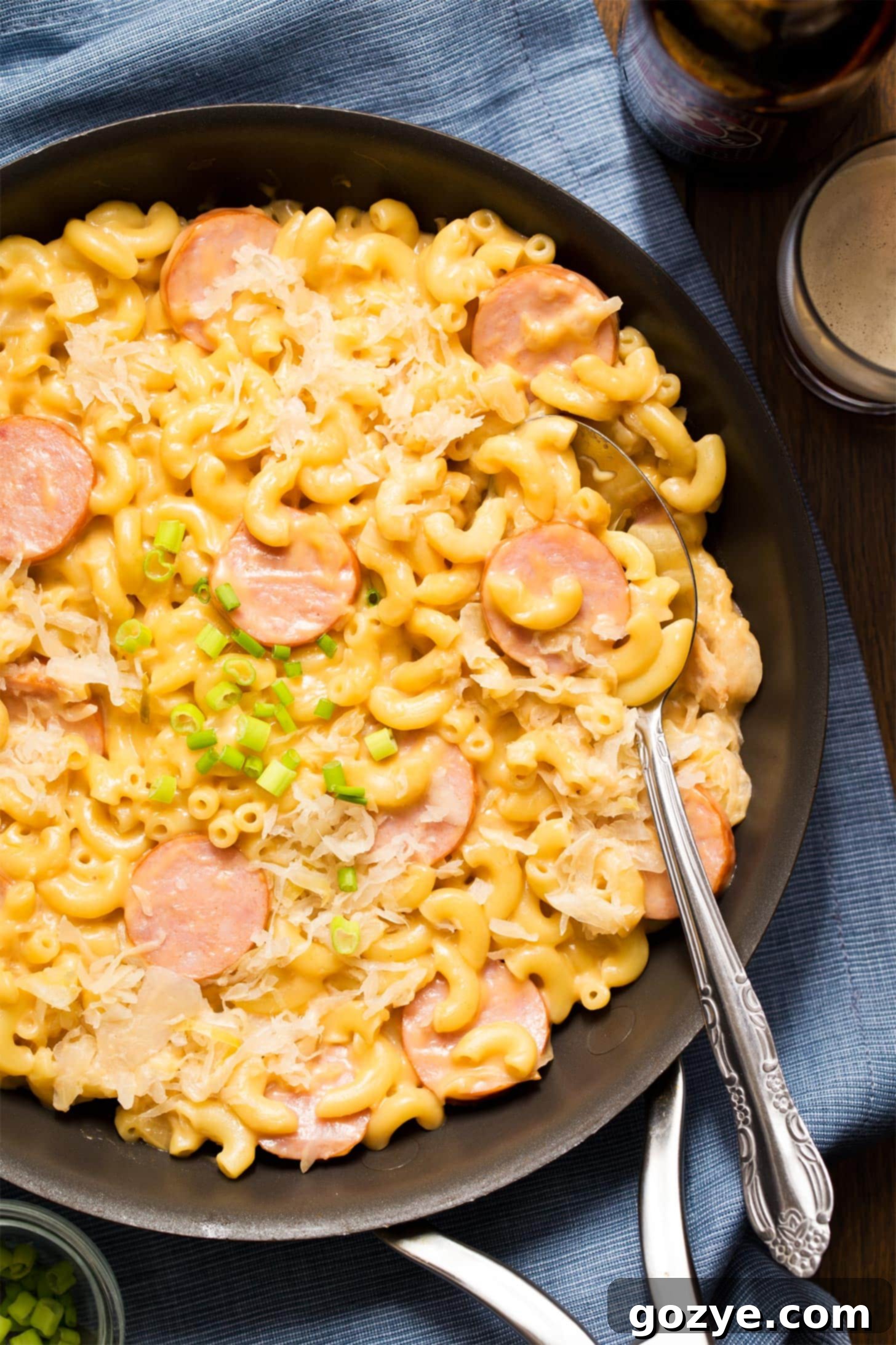 Kielbasa Mac and Cheese in skillet with spoon