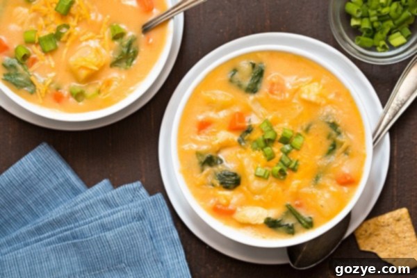 Hearty Cheesy Chicken Potato Chowder 3 Close-up of creamy Cheesy Chicken and Potato Soup with spinach