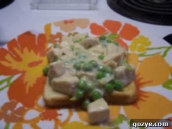 A inviting bowl of creamy Chicken à la King generously spooned over perfectly toasted bread.