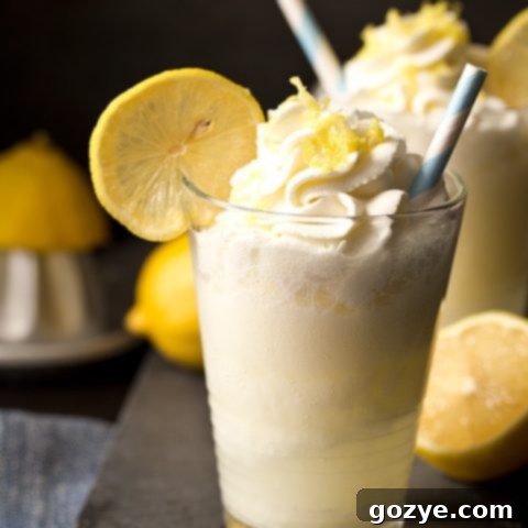 Lemon Drop Cream Soda in a glass with a lemon slice and whipped cream.