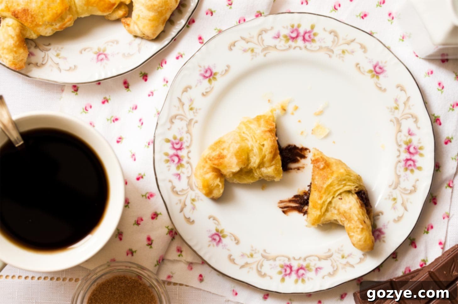 Small batch croissants cut in half with chocolate melting out