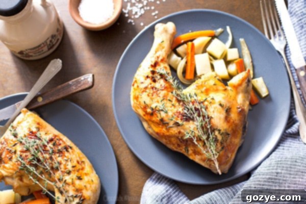 Plates of maple roasted chicken quarters and vegetables with a glass of wine