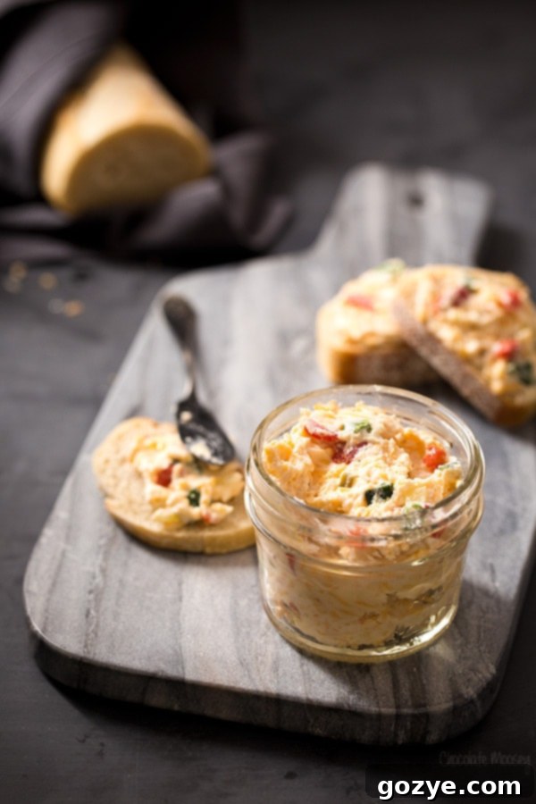Pimento cheese spread made with goat cheese, served in a bowl with crackers