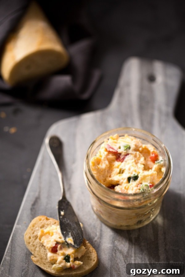 Pimento goat cheese spread in a bowl, with a spoon for serving