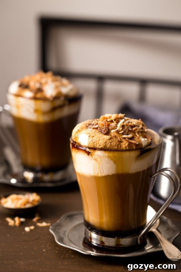 Close-up of a Toasted Coconut Mocha showing the layers of coffee, chocolate, and milk before adding toppings.