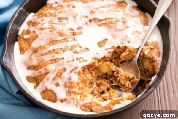 Delicious Carrot Cake Skillet Cake, ready to be served, topped with sweet vanilla glaze.