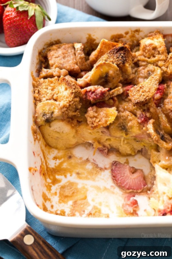 Overnight Strawberry Banana French Toast Bake baking in the oven, golden brown and bubbly