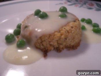 Homemade Salmon Patties with Creamed Pea Sauce, garnished and ready to serve.