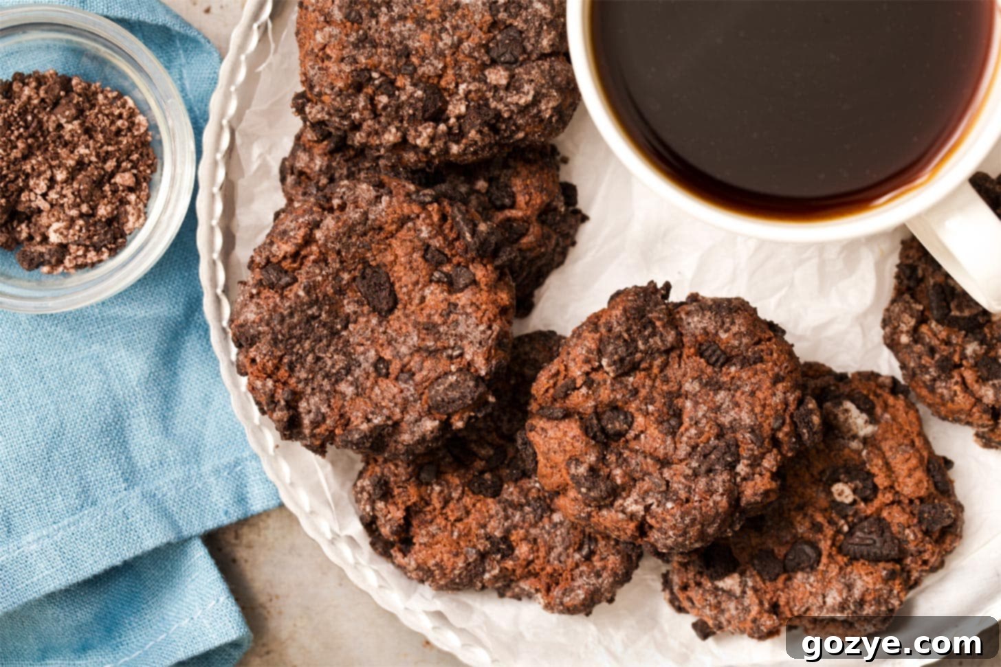 Cookies and cream cheesecake cookies arranged on a plate with coffee, highlighting the crumb texture