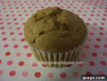 A freshly baked coffee-break muffin with a golden brown top, resting on a cooling rack.